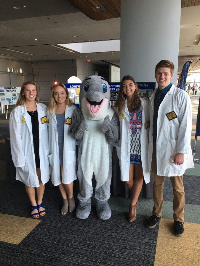 Pictured (from left to right): Jenny Freebus, Emily Walton, Spirit the Dolphin, Andrea Seyrlehner, and Tyler Caron.