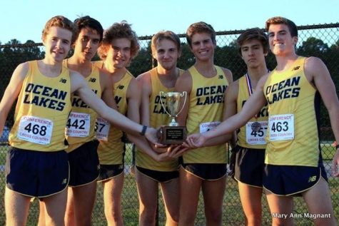 The cross country boys hold their Coastal Conference Championship trophy on October 26 at Kellam High School. Left to right sophomore Will Spollen, senior Sean Burtner, senior Dillon Schweers, junior Brent Bailey, junior Jacob Bushey, sophomore Tyler Lipps, and junior CJ Reed.
Photo by Mary Ann Magnant.