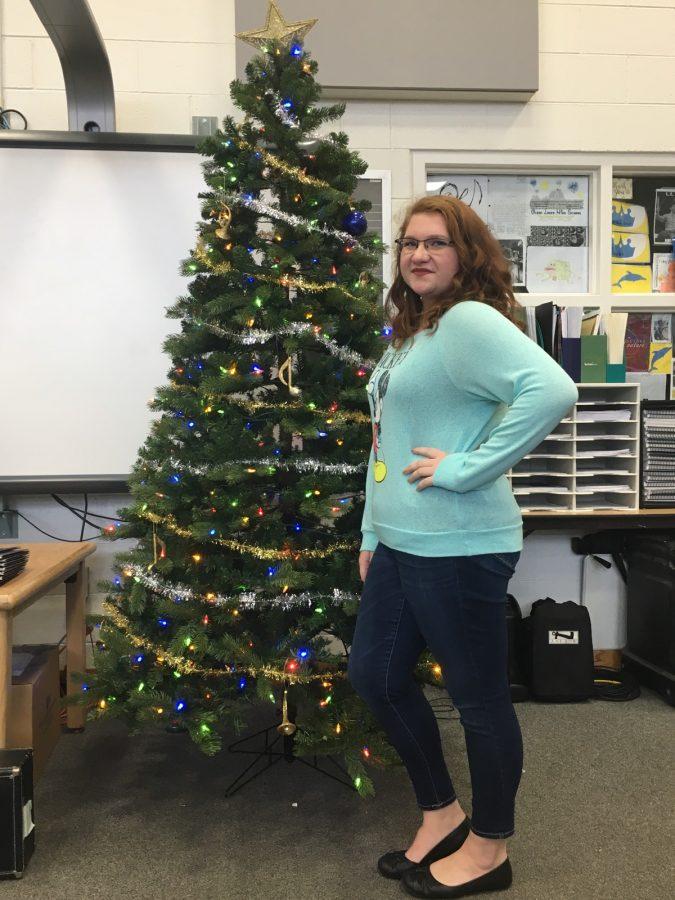 Keita Gain is standing by the Christmas tree in the band room 111. Photo by Makenna Miller on December 7, 2016.