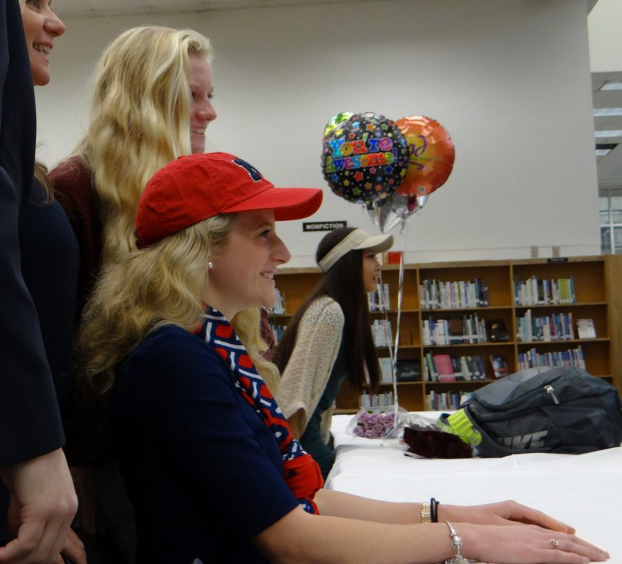 Madeleine King poses with parents and sister Meredith King for signing day photos.