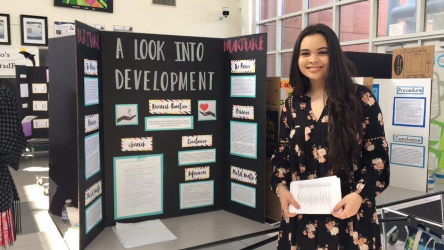 Math and Science Academy Junior Charlotte Delumpa-Alexander stands by her symposium project A Look into Development: Nature vs. Nurture at the MSA Symposium at Ocean Lakes High School on January 25. 