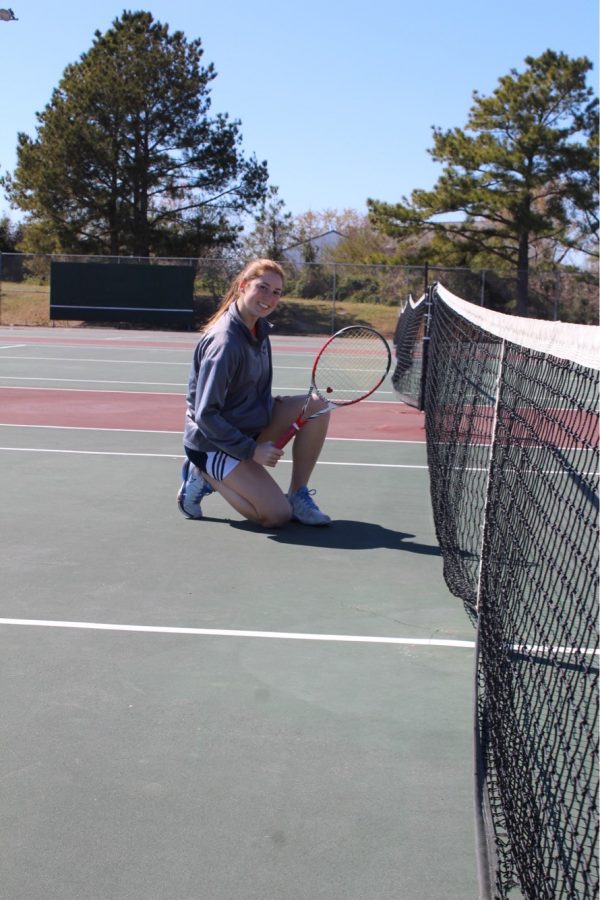 Kiersten posing next to the tennis net on the Ocean Lakes tennis court in March of 2017.