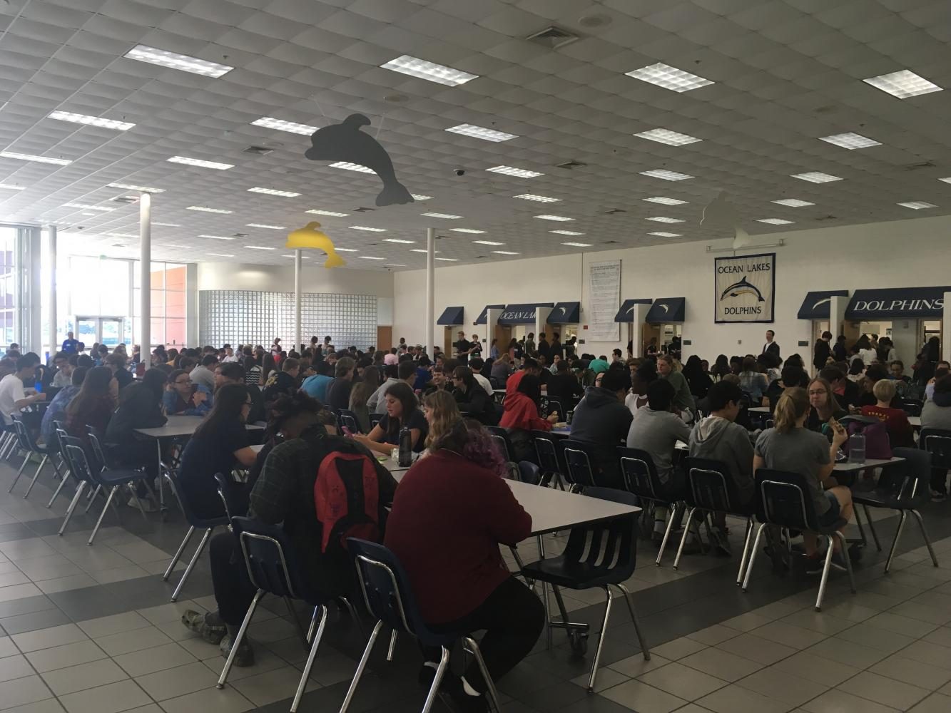Students eat their lunch in the cafeteria during third lunch on May 2.