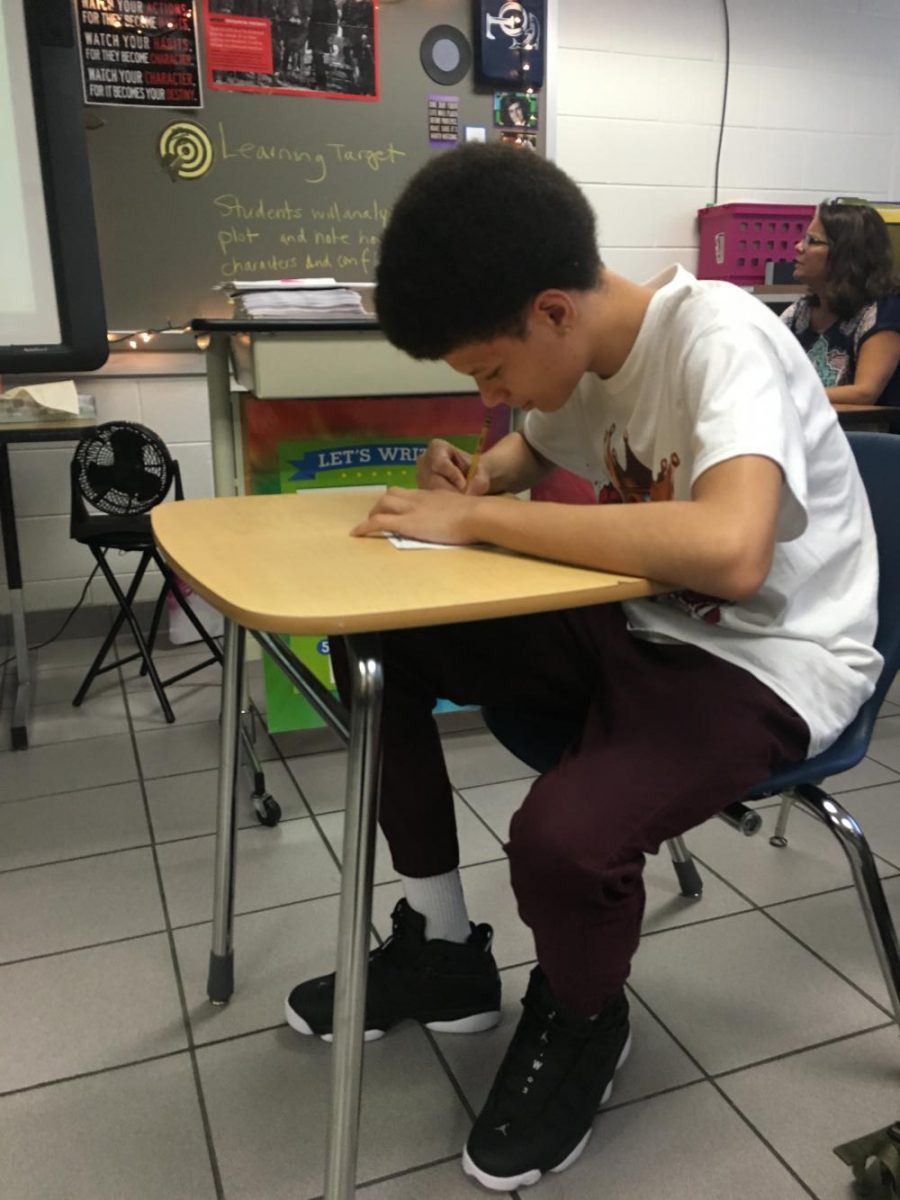 Depicts Isaiah Wright writing 
down his long term goals. 
Picture taken by Makenna Miller
