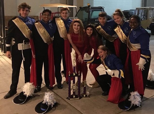 Band and guard members (left to right) Ryan Boylan, Romeo Manoza, Hunter Cigich, Paige Zuchristian, Kaley Cotner, Brianna Calkins, Charles Via, Sibley Brown, and Reehan Siraj pose after their successful performance.