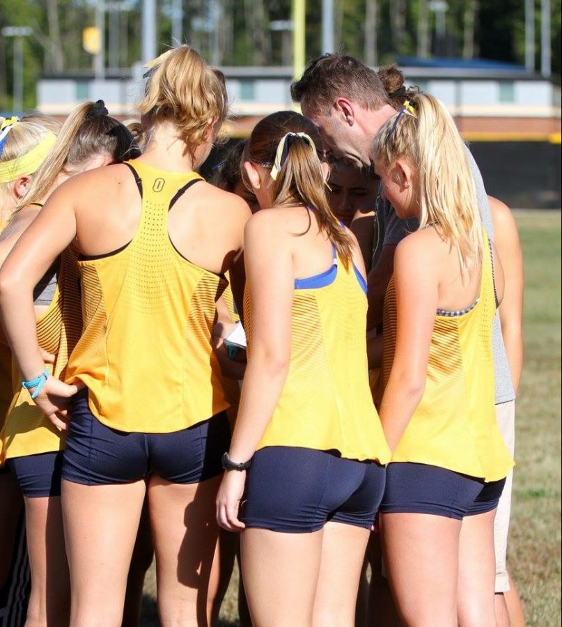 Girls team huddles with Coach Nestor at Beach Championship. Photo by Mary Ann Magnant. 