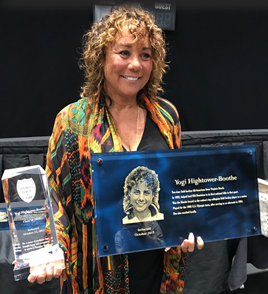 Yogi Boothe stands with plaque and award received from Hampton Roads Hall of fame.