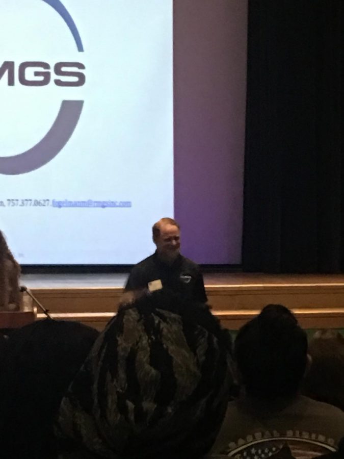 Fogleman speaks to hundreds of teens in the auditorium.