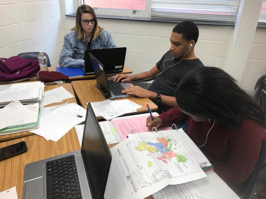 (Students from left to right) Sophomores Ella Silvernail, Xavier Adams, and Javahdi Germain listen to music while they study in Christina Frierman’s 3B English class.
