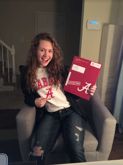 Cynthia shows off her acceptance letter and school pride