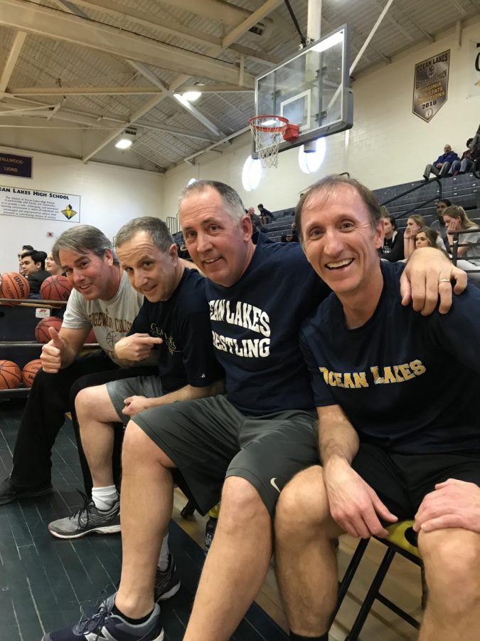 David Lehan, Jim Cartwright, Peter Zell, and Andy Bedinger relax after a faculty win on March 16.