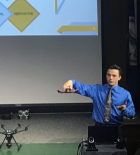 Senior Chet Wiltshire demonstrates how drones fly in his magnet presentation on Tues., March 6.
