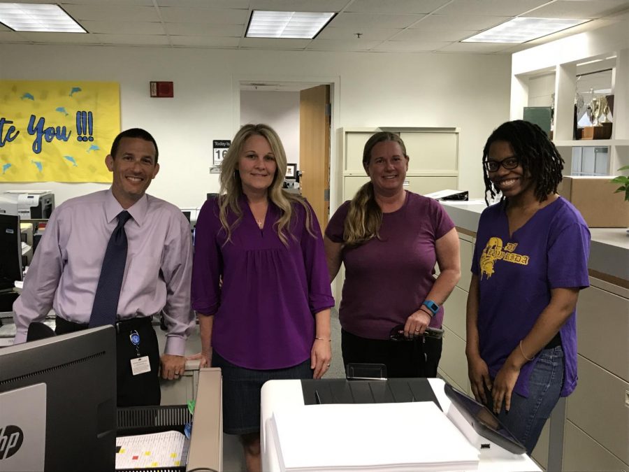Faculty Members James Imbriale, Lori Tignor, Marsha Sablan, and Ericka Chambers Purple Up in the front office.