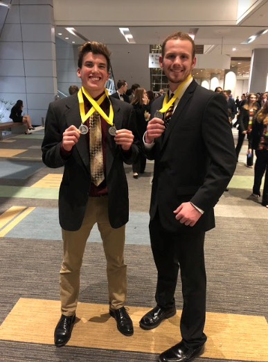Seniors CJ Reed and Chris Levine pose with their medals at the Virginia Beach Convention Center.