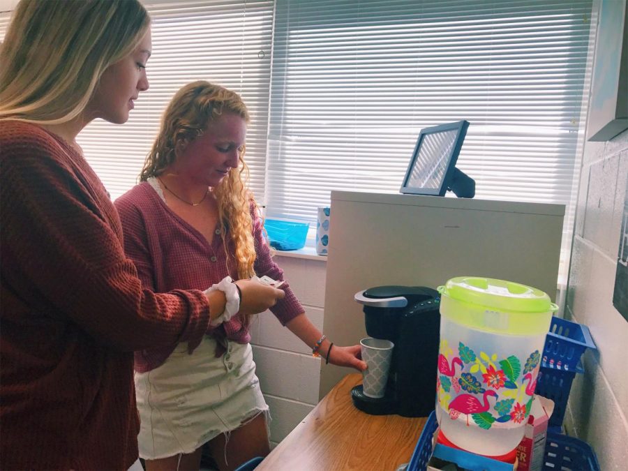 Juniors Sara Luper and Lauren Barakey make coffee with Darcy Pohl's Keurig before their AP US History class. Sept. 26, 2018