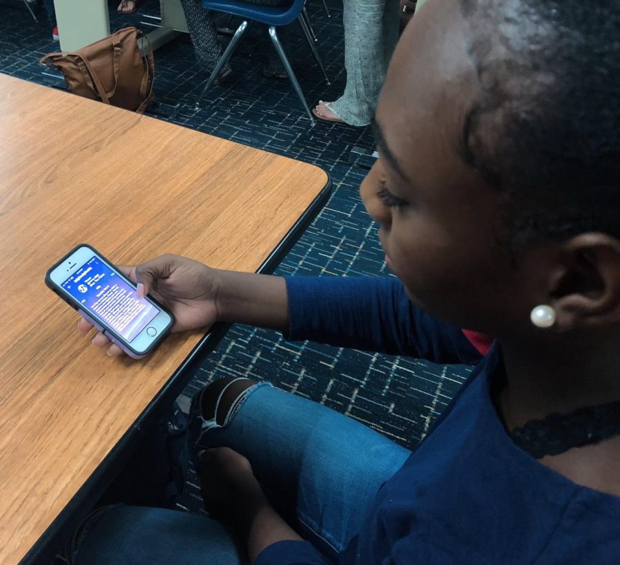 Junior Jaelese Peavy reads through dailly horoscope app during her free period on Oct. 10.