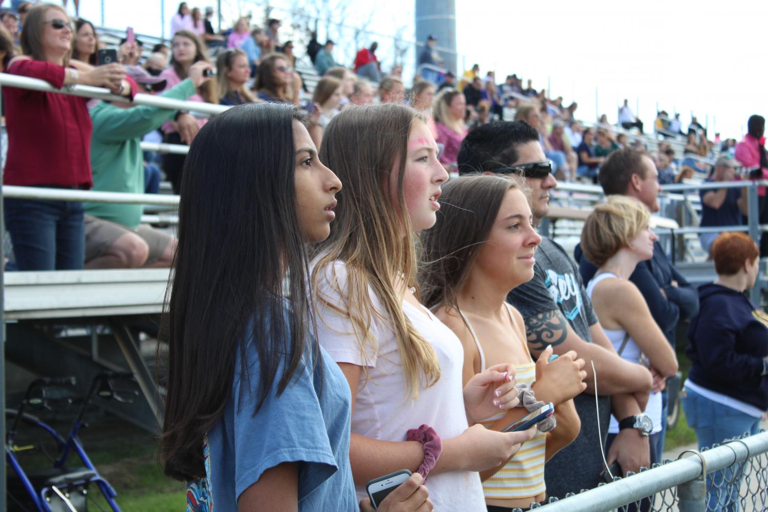 Sophomores (from left to right) Meher Mohann, Kristin Glasier, and Kelly McCarty
attentively watch the Homecoming game on Oct. 13.