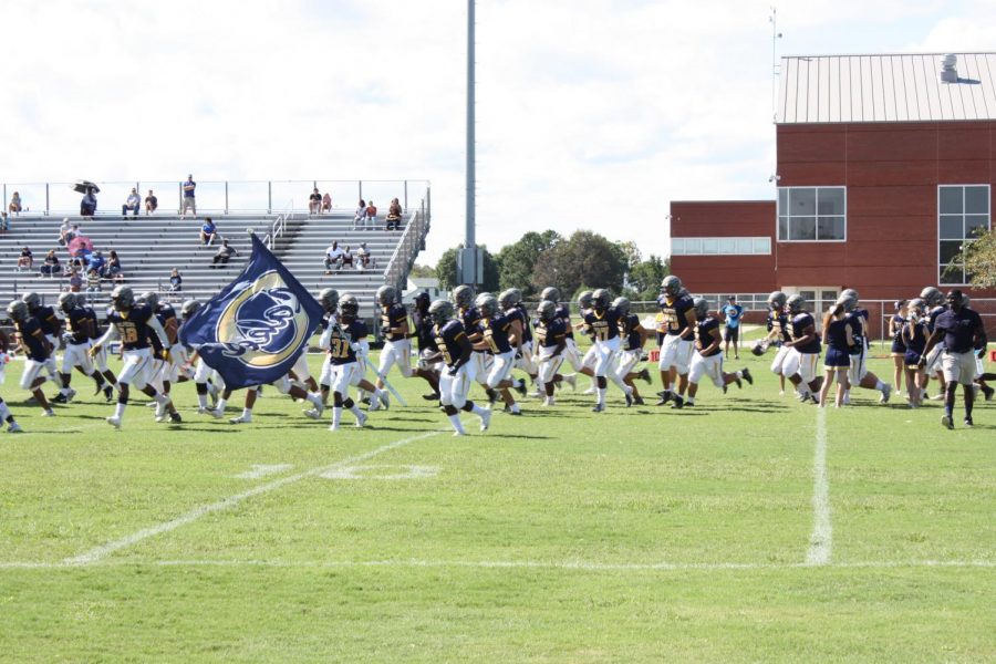 The Dolphins run onto the field prior to their 10-6 win against Landstown at Ocean Lakes HS on Sept. 29, 2018.