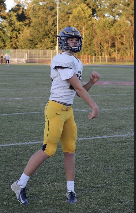 Quarterback+Xander+Jedlick+warms+up+before+leading+his+offense+to+victory+at+Kempsville+H.S.+on+Oct.+19.+Photo+by+Jackson+Ploeger.