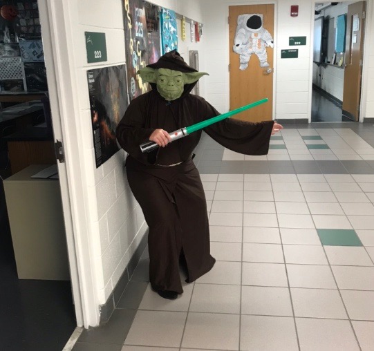Astronomy teacher Michelle Bailey-Hennessey in her Yoda costume outside room 233 on Halloween.
