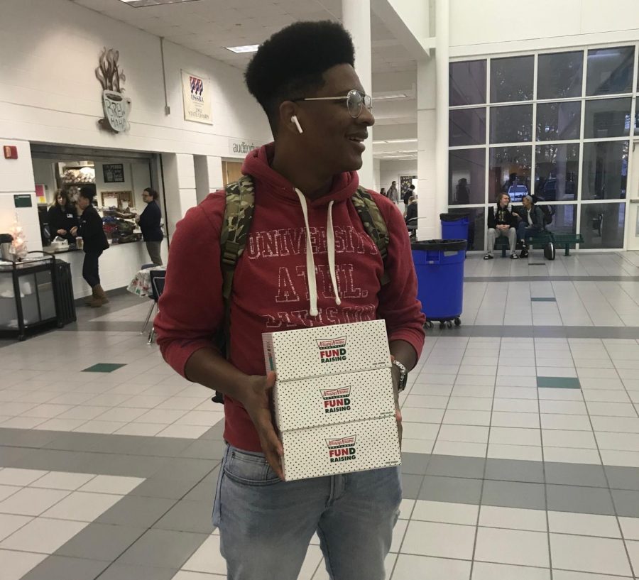 Senior Malik Thomas after buying donuts from the AVID stand in front of the cafeteria on Friday, Dec. 7.
