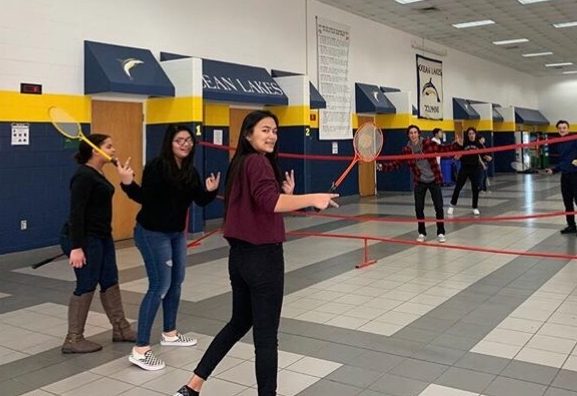 Badminton members pose for a picture before resuming a friendly match on Jan. 9 in the cafeteria.