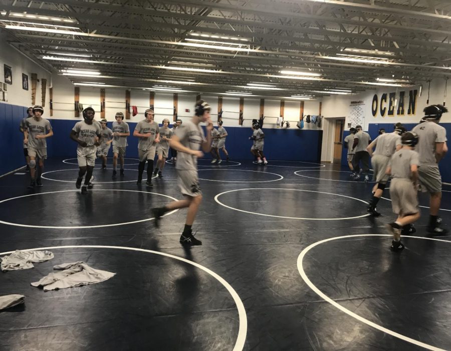 Wrestlers warm up, preparing for the match on Wed., Jan. 23. Photo taken by Desiray Martinez in the mat room on Jan. 23.
