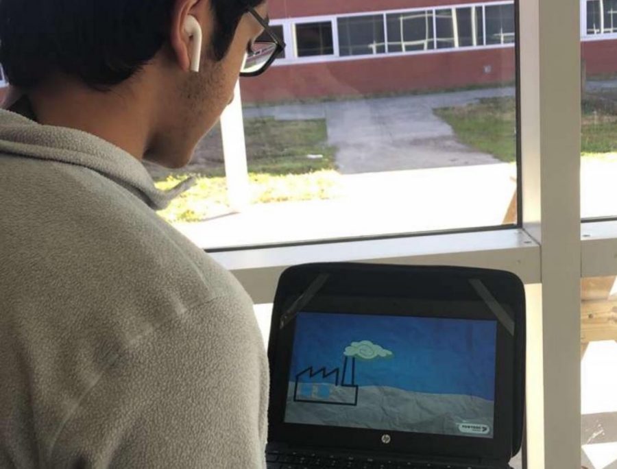 Junior Saighuhan Sai Senthilkumar watches the film he made for the 2018 Bow Seat Ocean Advocacy Competition on Feb. 8.
