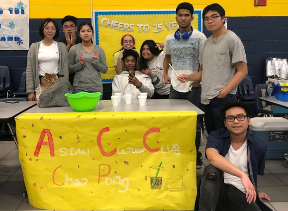 The Asian Culture Club poses at their booth at the Winter Carnival in the cafeteria on February 8, 2019.