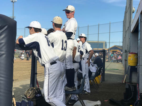 From left: Max Kuhl, Braden Ward, Will Webb, and Aiden Pinto support their teammates in the home dugout. 