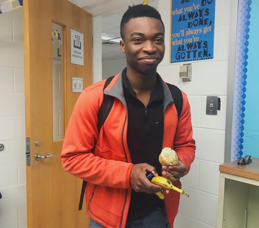 Senior Nelson Soga grins after a group of friends surprise him with a birthday muffin on Feb. 25 in the Dolphin Workroom. 