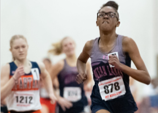 Aniya Mosley takes a first-place lead in the 1000 meter at the 6A State track meet at Boo Williams.