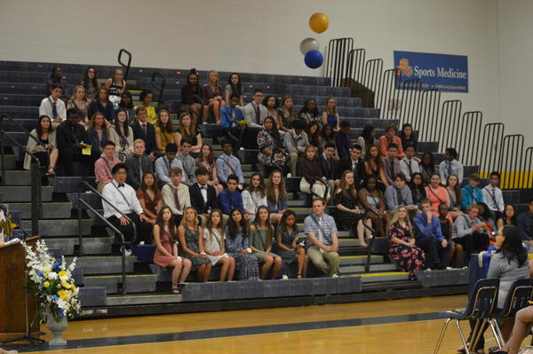 New NHS inductees sit in gymnasium for induction ceremony on April 25. 