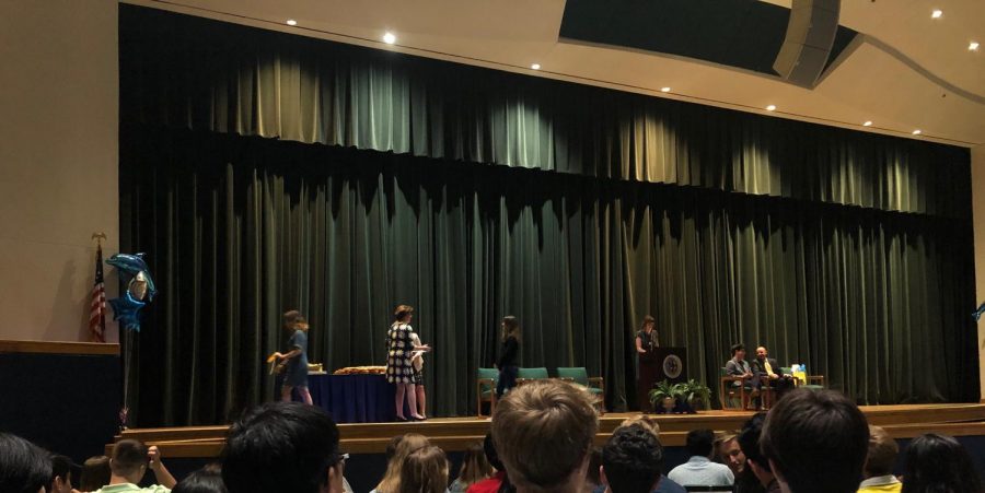 Sophomore Andrea Ayala walks across the auditorium  stage to receive her first academic letter on May 31, 2019. 