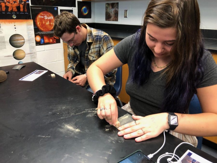 Seniors (from left to right) Alexander Bowles and Lillian Ayres sand the pieces of wood in Astronomy teacher Michelle Bailey-Hennessey’s advisory. Photo on May 1, 2019