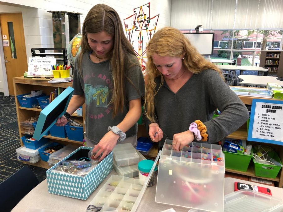 Juniors (from left to right) Brooke Sullivan and Lauren Barakey pick out beads for their bracelets. Photo on May 16, 2019