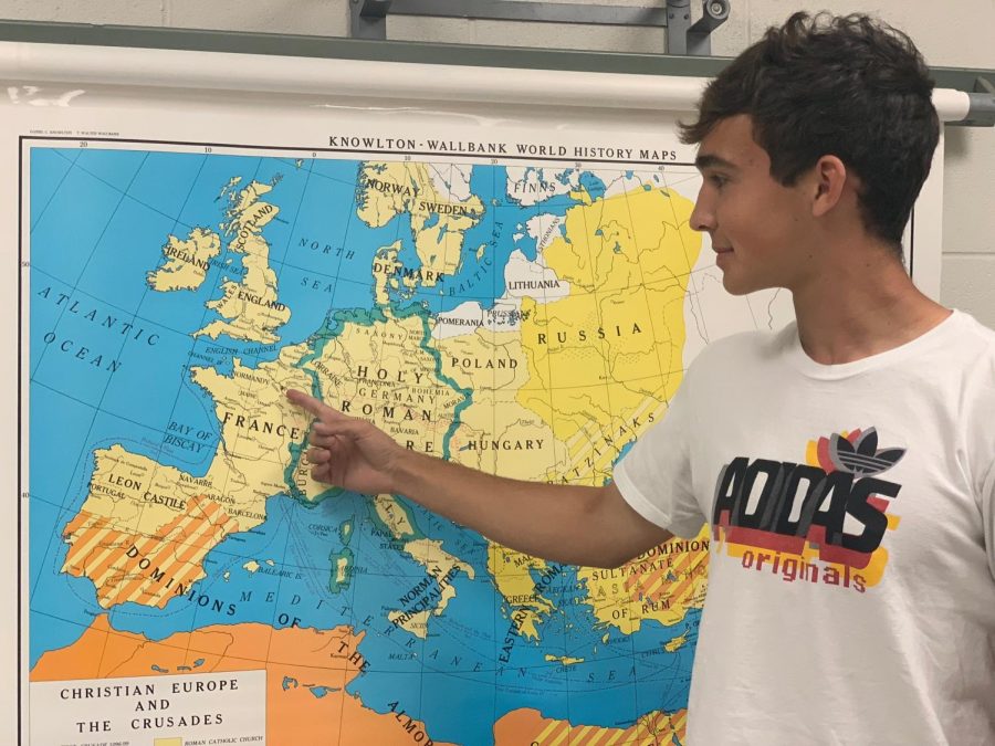Richard Butzlaff points out the many places he has traveled in Europe in the Social Studies office. 