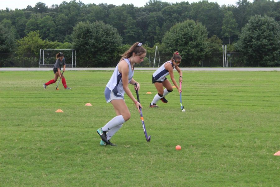 Junior+Kelly+McCarty+and+sophomore+Kaitlyn+Hertz+dribble+the+ball+during+a+conditioning+drill+on+July+19.