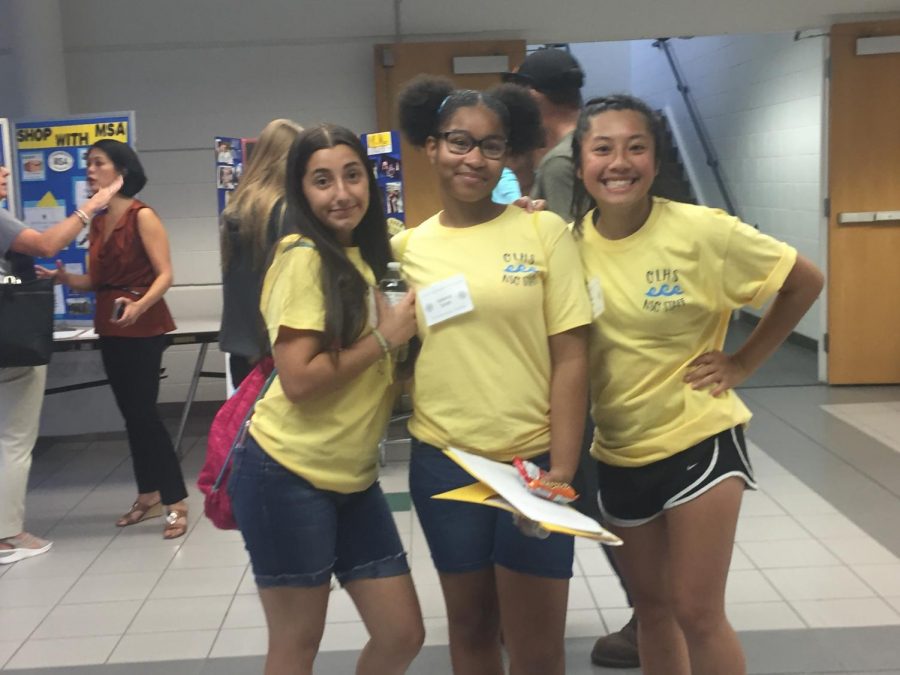 Student volunteers wear yellow t-shirts to distinguish themselves as team guides. 