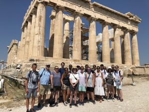 Students and teachers stand in front of the Parthenon in Athens, Greece.
