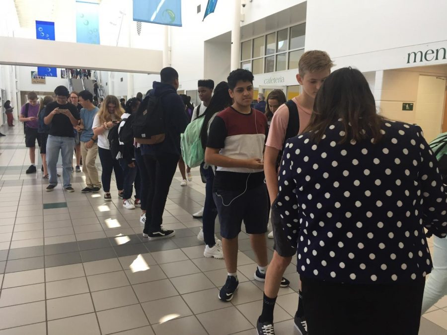 Sophomore Cooper Crouse, junior Juan Vanegas head to pick up pre-ordered lunch in front of cafeteria.