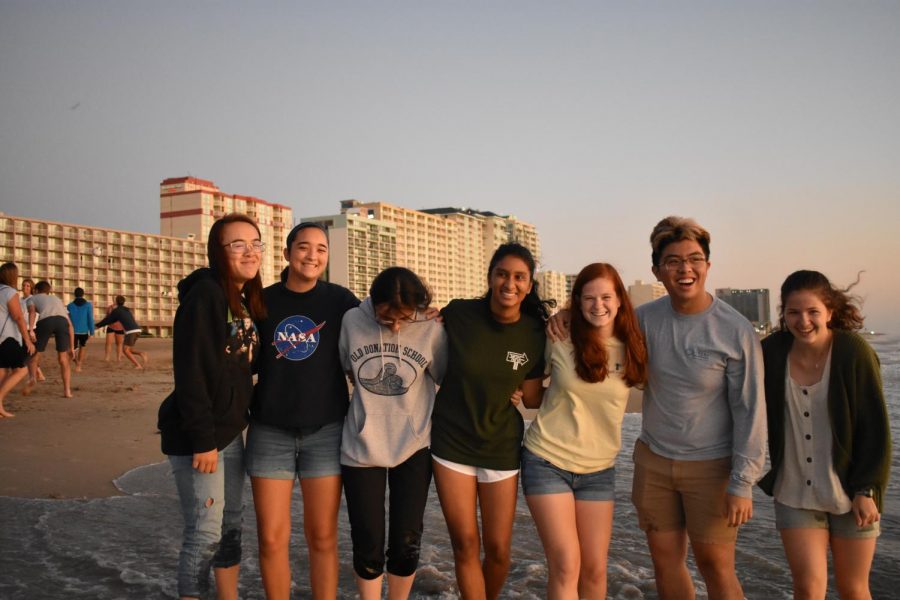 A cluster of seniors group together for a picture at the oceanfront on August 30.