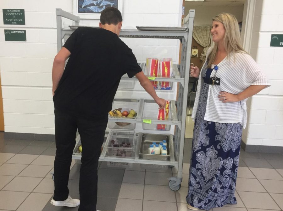 Junior Shane Thomas picks up his pre ordered lunch from administrator Lindsey Comfort on Sept. 18. 
