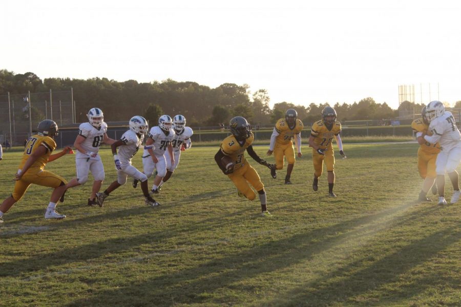 Sophomore wide receiver Caleb Johnson evades defenders in a JV football game at Ocean Lakes on Sept. 19.