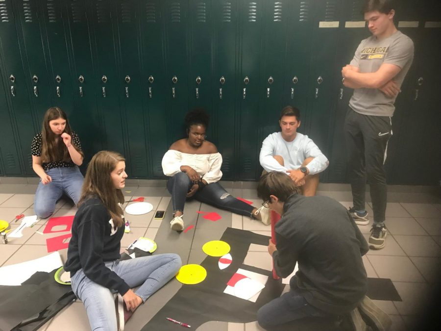 Students from Alexis Jones’ AP Literature class create a visual art project to depict the major themes of the government’s “all seeing eye” and womens oppression. Photo by Josh Garcia.