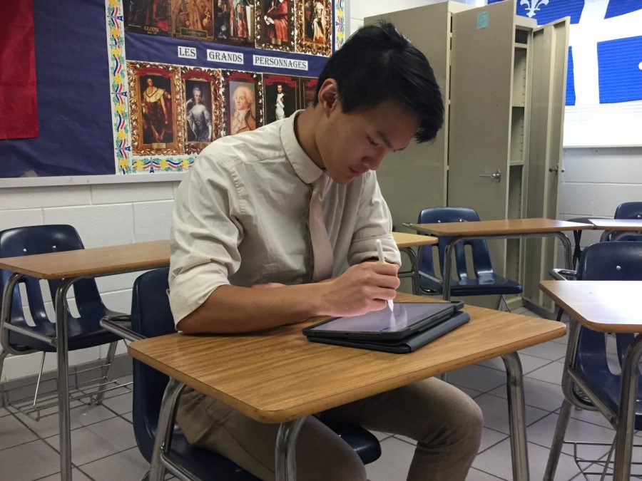 Vi Giang completes his most recent science assignment in room 251. Photograph taken by Alexia Fenner. 