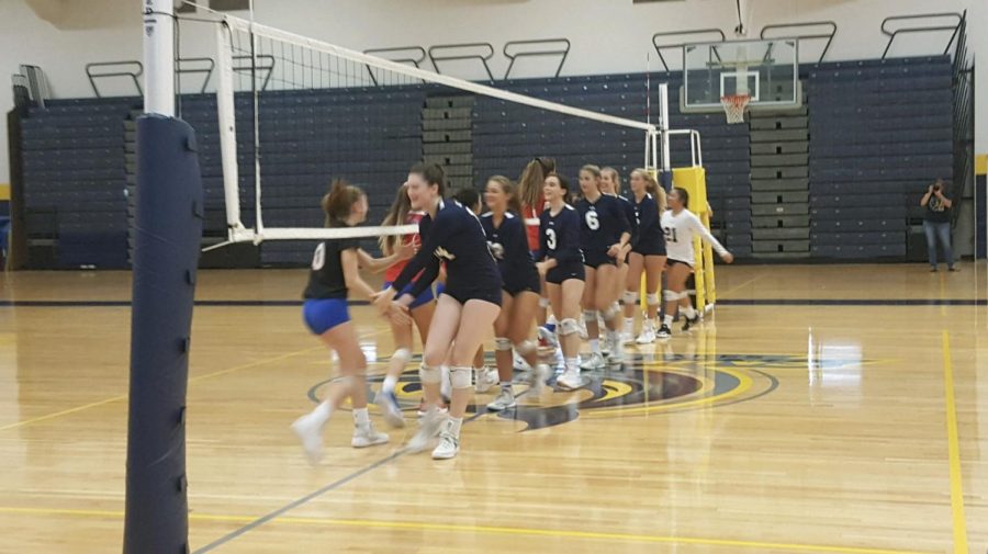 Girls volleyball shakes hands with Princess Anne before a game in the gym on Sept. 25.