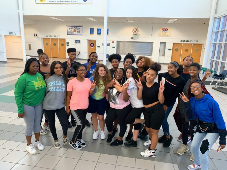 Step team poses for a photograph at practice in the cafeteria foyer on Oct. 23.