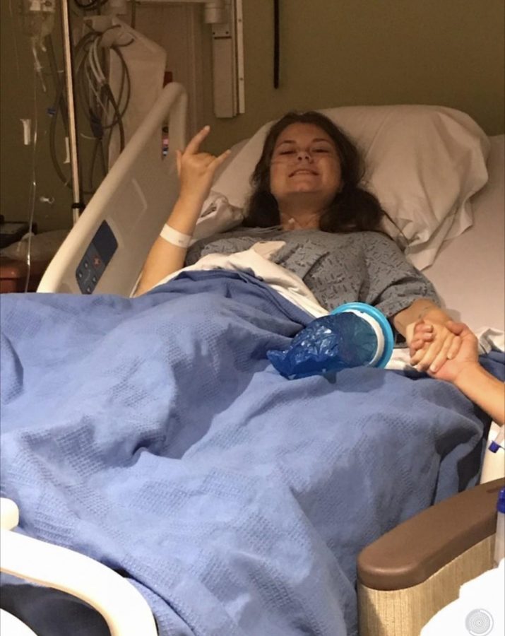 Sarah Bell gives the rock on hand gesture in July 2017 after surgery. 