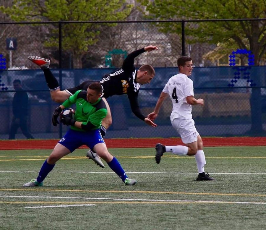 Ben Lockler, pictured in green, wins possession of the ball  in the the Air-Force vs All-Army game April 2019. 